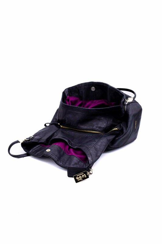 Bolsa negra de piel con forro morado y diseño texturizado